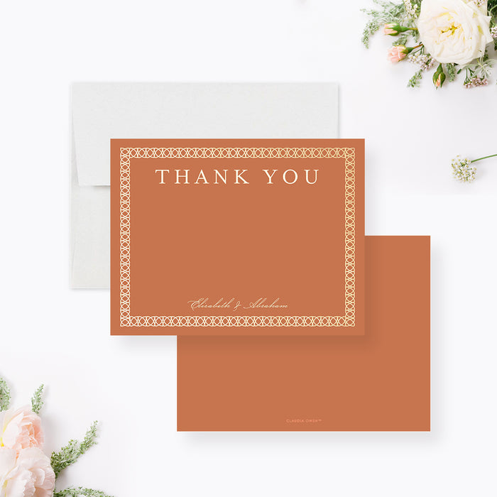 Burnt orange wedding thank you note card with an intricate cream patterned border and personalized couple's names.