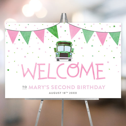 Kids' birthday welcome sign featuring a green school bus illustration, pink and green bunting, and confetti, making a fun event decoration for children’s parties.