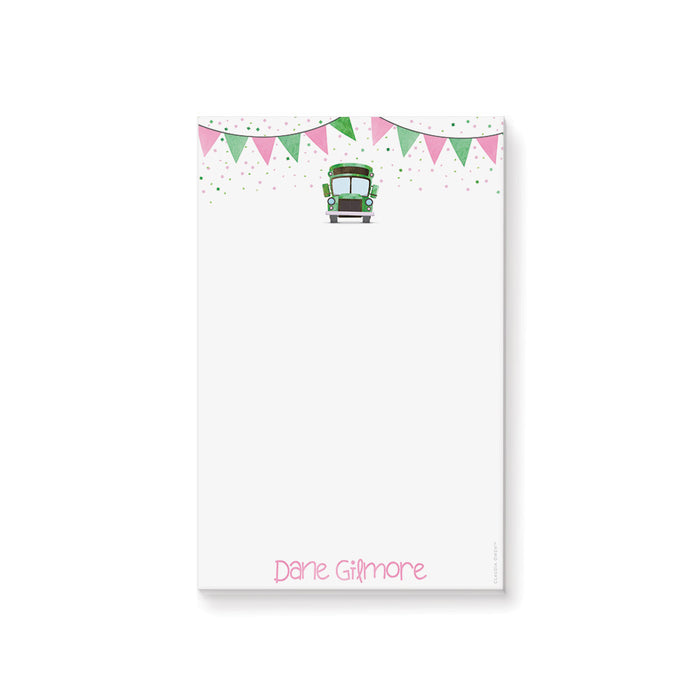 Kids notepad with a green school bus, pink and green bunting, and confetti design, perfect as a fun children’s doodle pad or stationery gift.
