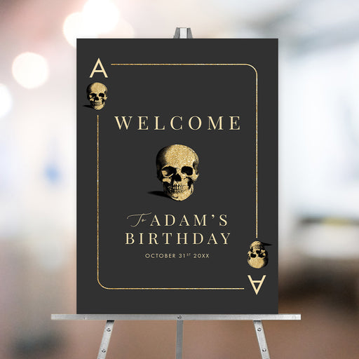 Black casino night birthday welcome sign styled as an ace playing card with gold skull illustrations, honoree’s name and event date