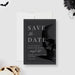 a black and white save the date card with a skull on it