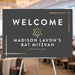 Charcoal gray and gold Bat Mitzvah welcome sign with a gold Star of David, personalized name, and celebration date.