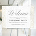 Elegant Christmas party welcome sign displayed on an easel, featuring a festive minimalist design for holiday events and celebrations.