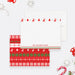Personalized Christmas note card front and back, with a family name and a red and green ugly sweater pattern of reindeer, trees and snowflakes.