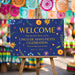 Cinco de Mayo welcome sign with colorful floral artwork, blue background, and fiesta party wording displayed on an easel