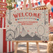 Vintage circus-themed birthday welcome sign featuring trapeze artists, stars, tents, and carnival rides