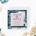 Ocean-themed wedding save the date card featuring a blue wave design-front