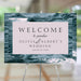 Ocean-themed wedding welcome sign with blue wave background