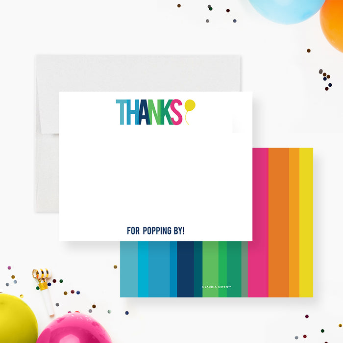 White birthday thank you note card with multicolor Thanks lettering and For Popping By wording at the bottom.