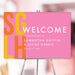 Modern pink wedding welcome sign with bold yellow and orange initials, customizable names, and date, displayed on an easel.