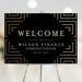 Elegant welcome sign with a gold geometric pattern, displayed at a company dinner or corporate event entrance.