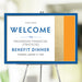 Elegant personalized welcome sign with blue, gold, and orange accents displayed at the entrance to a corporate or charity event.