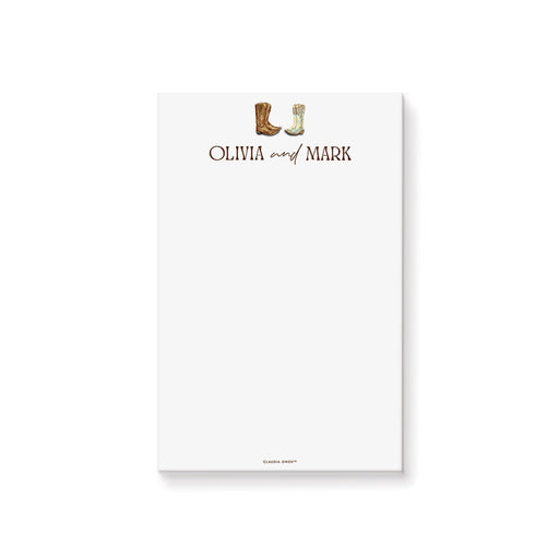 Personalized western wedding notepad featuring cowboy and cowgirl boots on a rustic wood background for country wedding stationery.