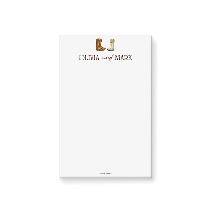 Personalized western wedding notepad featuring cowboy and cowgirl boots on a rustic wood background for country wedding stationery.