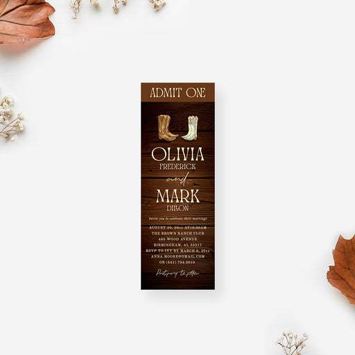 Rustic western wedding ticket invitation featuring cowboy boots on a dark wood background with elegant rustic typography.