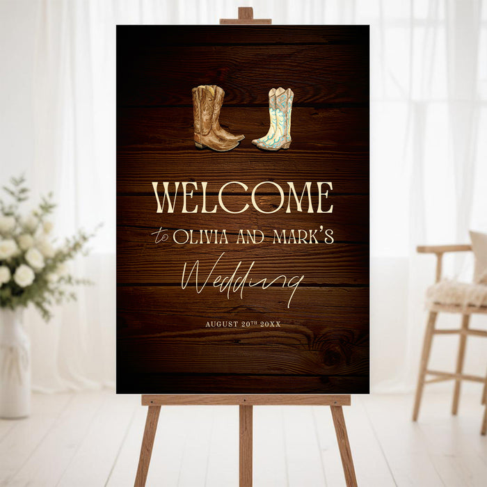 Rustic western wedding welcome sign with cowboy boots illustration on a dark wood background displayed on an easel.