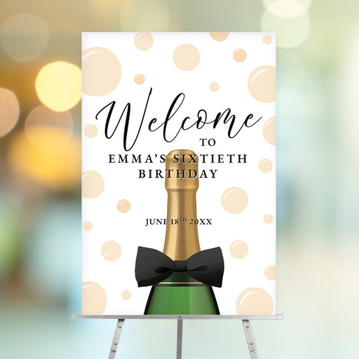 Elegant champagne birthday welcome sign featuring bubbles, a bowtie, and a champagne bottle design, ideal for milestone celebrations.