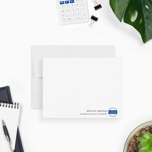White business note card personalized with a company name, logo and contact details along the bottom.