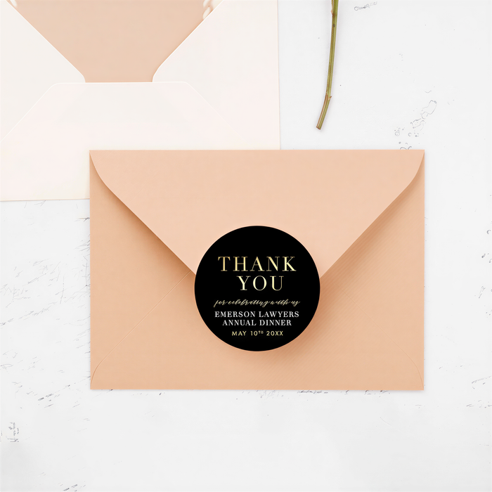 A peach-colored envelope with a black circular sticker that says "THANK YOU" and "for celebrating with us EMERSON LAWyers Anniversary May 10th, 2020".