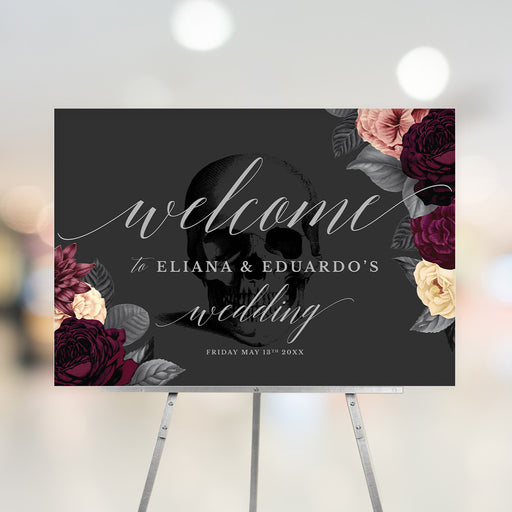 Gothic wedding welcome sign featuring a skull and burgundy floral design, personalized with the couple's names and date on a black background.