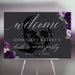 gothic welcome sign for a "Death to My 20s" party, featuring a skull and purple roses on a dark background, displayed on an easel