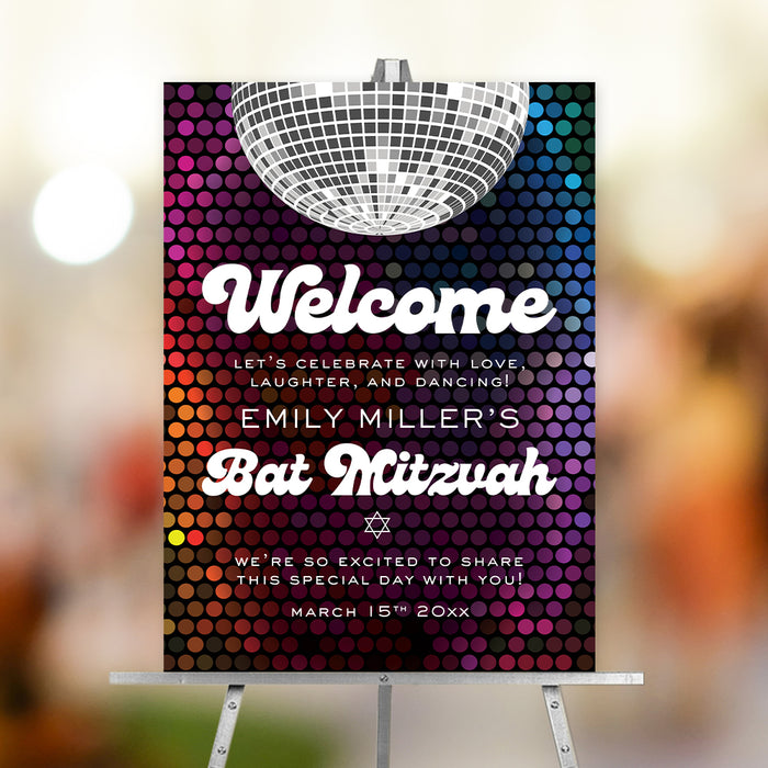 Bat Mitzvah welcome sign on an easel, featuring a retro disco ball, a colorful background, and groovy white lettering.