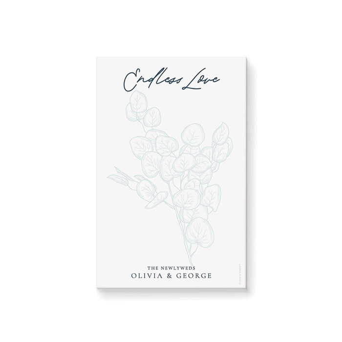 personalized botanical notepad with pale blue foliage design, elegant script lettering, and the newlyweds' name