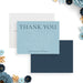 personalized blue botanical wedding thank you card with elegant thank you lettering, line art floral details, and custom couple names-front-back