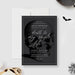 a black and white photo of a skull on a card