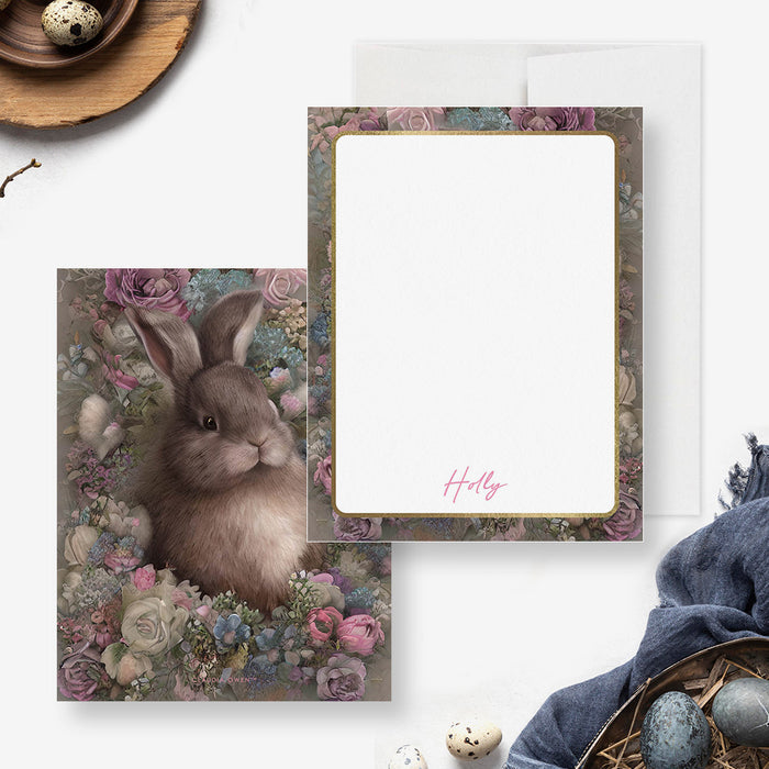 Easter note card featuring a realistic brown bunny surrounded by vintage-style flowers with a gold frame and space for personalization.