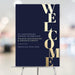 Editable navy and gold-effect business event welcome sign with oversized vertical WELCOME lettering displayed on an easel