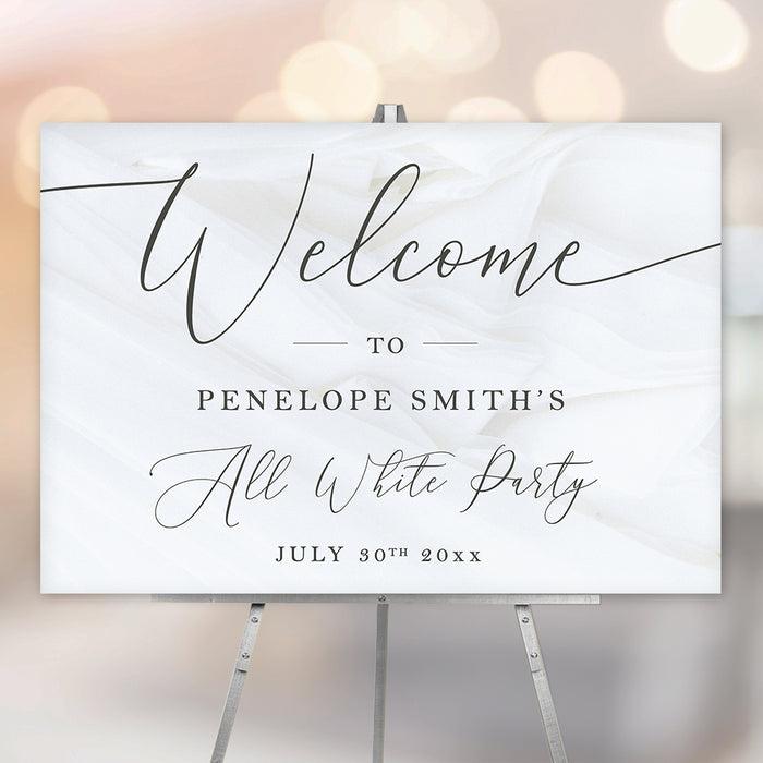 all white party welcome sign with elegant black script lettering, custom event details, and modern minimalist design displayed on an easel