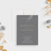 elegant gray baptism invitation with cross symbol, refined lettering, personalized child’s name, and religious celebration details-front