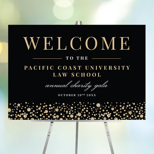 Black and gold gala welcome sign with gold typography and diamond confetti accents for formal corporate or charity event entrance display.