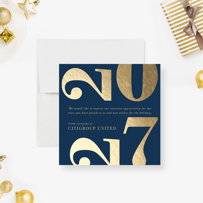 Navy blue card with gold text '2017' surrounded by festive decorations on a white background