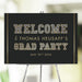 Black and gold graduation welcome sign with bold lettering for high school or college grad party celebrations