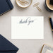 Elegant personalized thank-you card with navy script and matching envelope-front