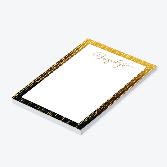 Personalized notepad with black border, sparkling light accents, and custom name in elegant script-side