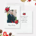 Elegant holiday photo card featuring a couple’s picture framed by red floral illustrations, with “Happy Holidays” text in script and matching floral accents on the back, styled with festive pinecones and ornaments.