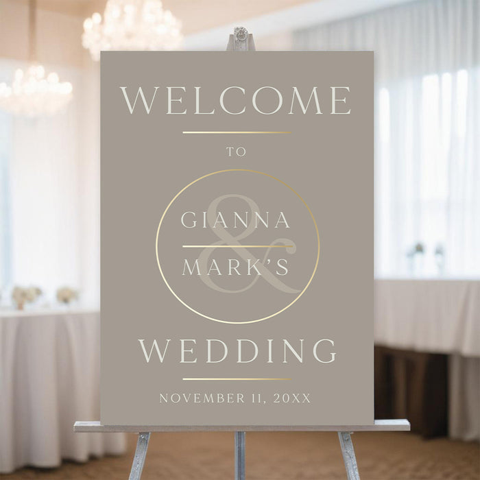 Elegant cream and gold welcome sign featuring an ampersand design, perfect for wedding reception venue decoration.