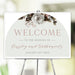 Wedding welcome sign featuring an arch design and vintage botanical florals, offering an elegant way to greet guests at your ceremony or reception.