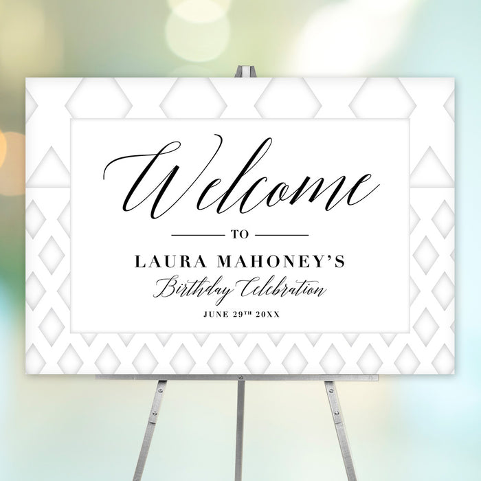 white geometric birthday welcome sign with elegant black lettering displayed on an easel for a milestone birthday celebration.