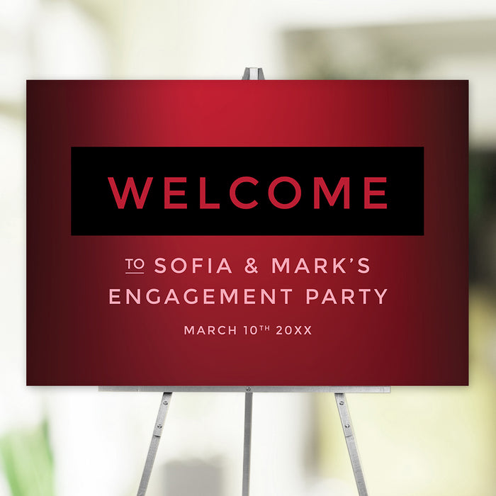 Red wine engagement party welcome sign with bold black and red design, displayed on an easel for event entrance décor.