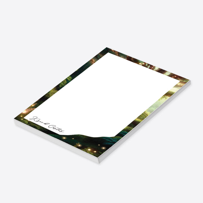 Personalized enchanted forest notepad with magical greenery border, glowing lights, and custom name-side