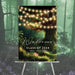 Enchanted forest welcome sign with glowing string lights and magical woodland background for prom event