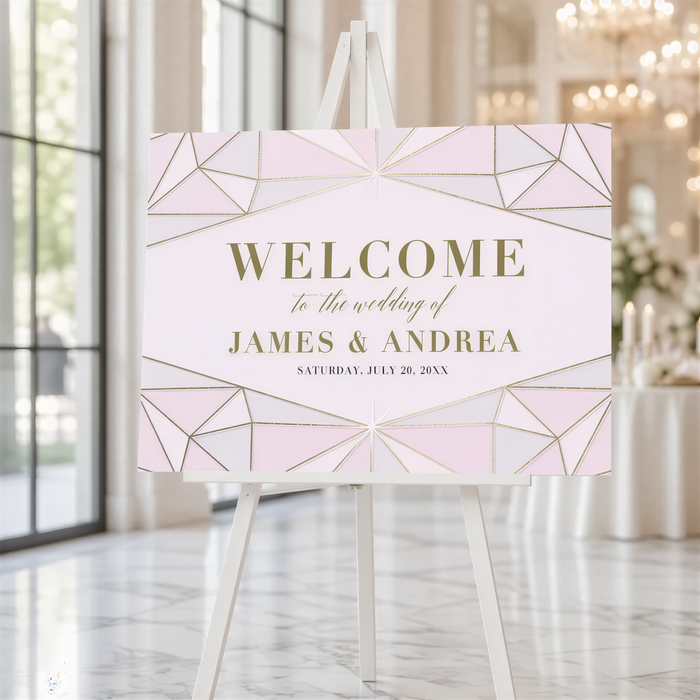 A white easel displaying a pink and gold geometric wedding welcome sign.