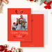 Family holiday photo card template featuring a red background, gift bow illustration, framed family photo and Warm Holiday Vibes greeting in a festive Christmas design