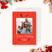Family holiday photo card template featuring a red background, gift bow illustration, framed family photo and Warm Holiday Vibes greeting in a festive Christmas design