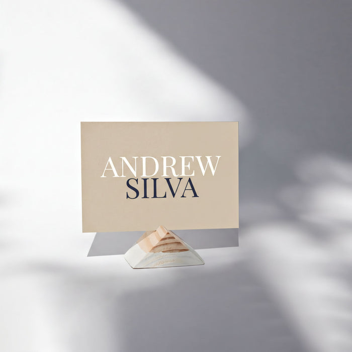 a name card with the name 'ANDREW SILVA' printed on it, placed on a stand.