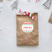 Brown paper bag with a festive 'Thank You' sticker on a light gray background